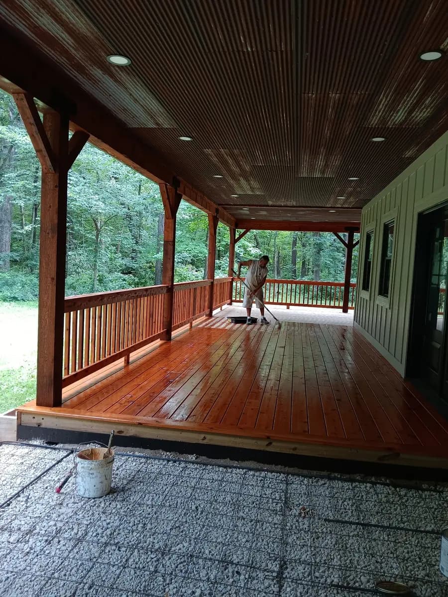 Restored covered porch with a cedar-toned wood finish.