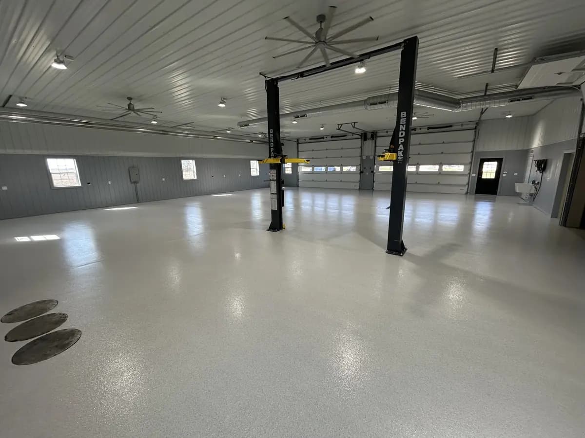 Wide commercial interior with a completed gray flake epoxy floor.