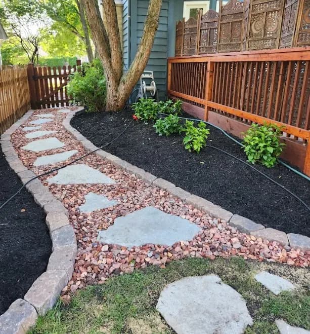 Stone walkway and landscaped bed detail.