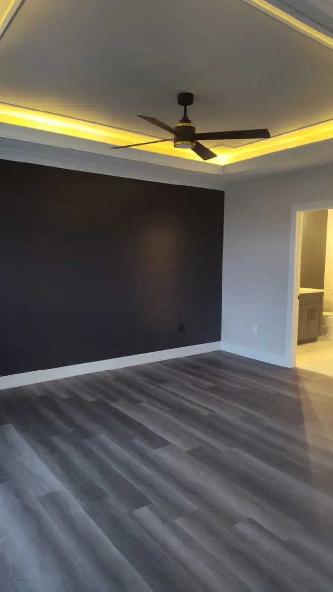 Finished living room with a modern painted accent wall.