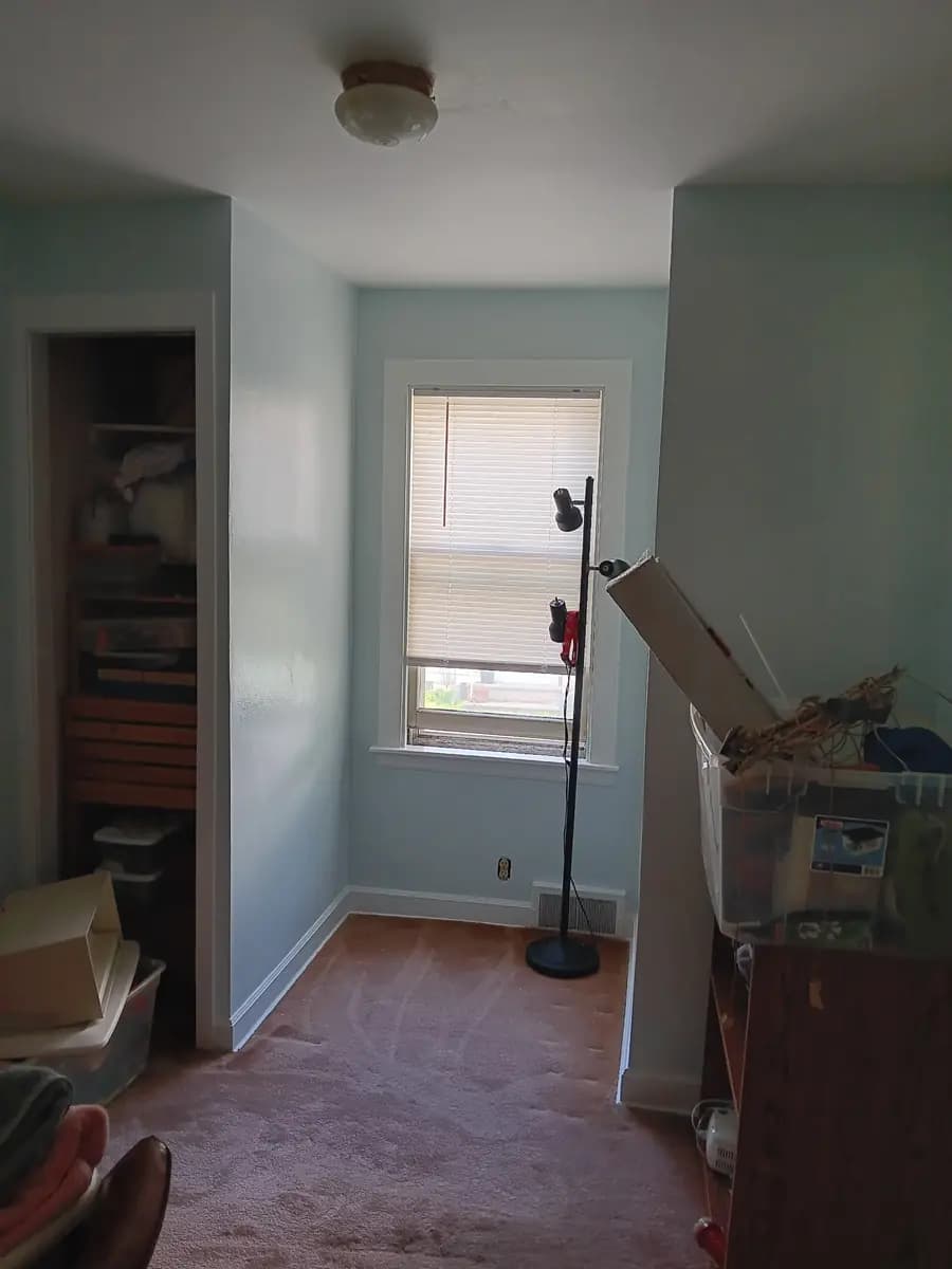 Repainted bedroom in the finished blue-gray color.