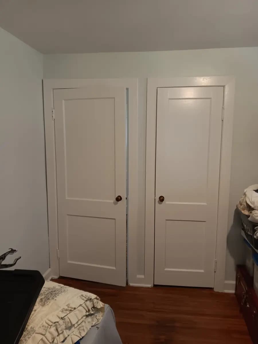 Matching closet doors repainted white with fresh trim lines.