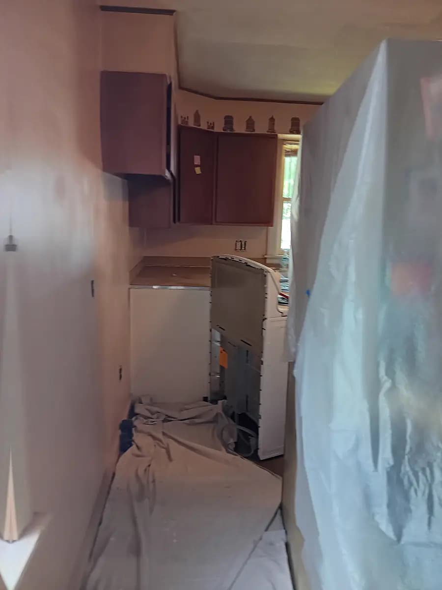 Kitchen surfaces masked and prepped ahead of painting.