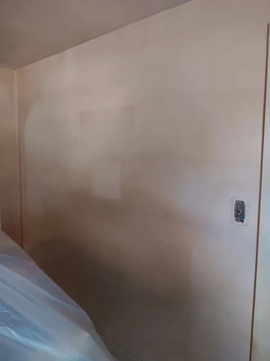 Wall priming in progress before the finish coat.