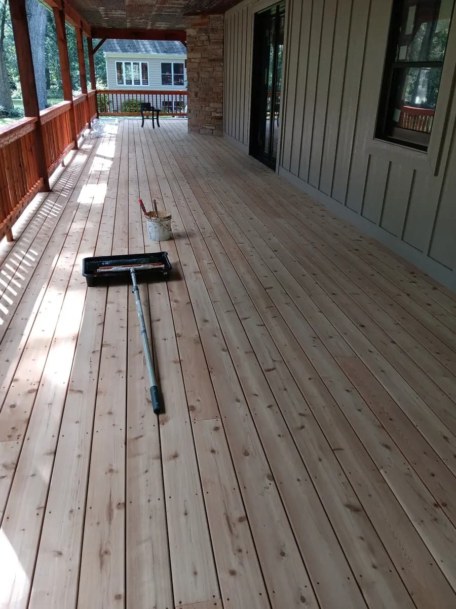 Wide view of porch decking during restoration and finish preparation.