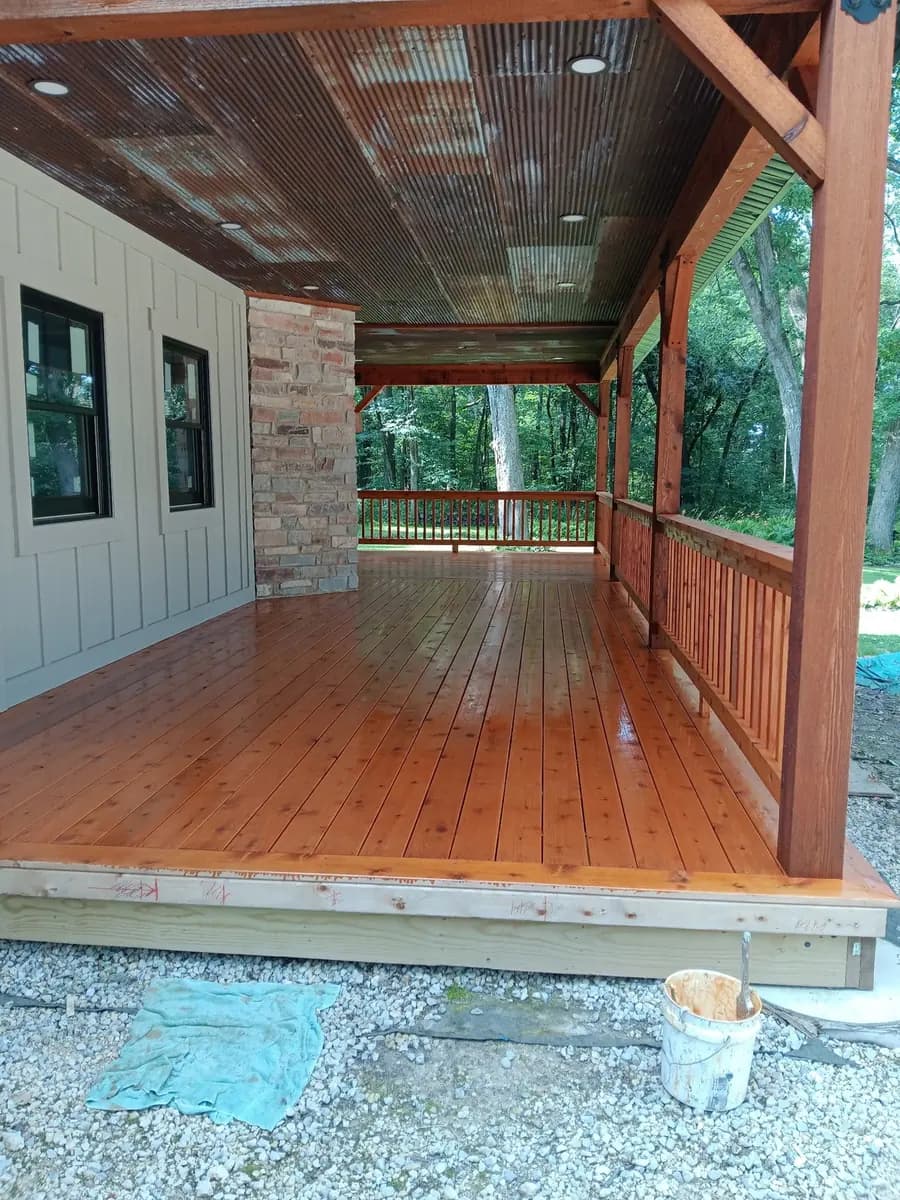 Finished covered porch entry with restored decking and railings.