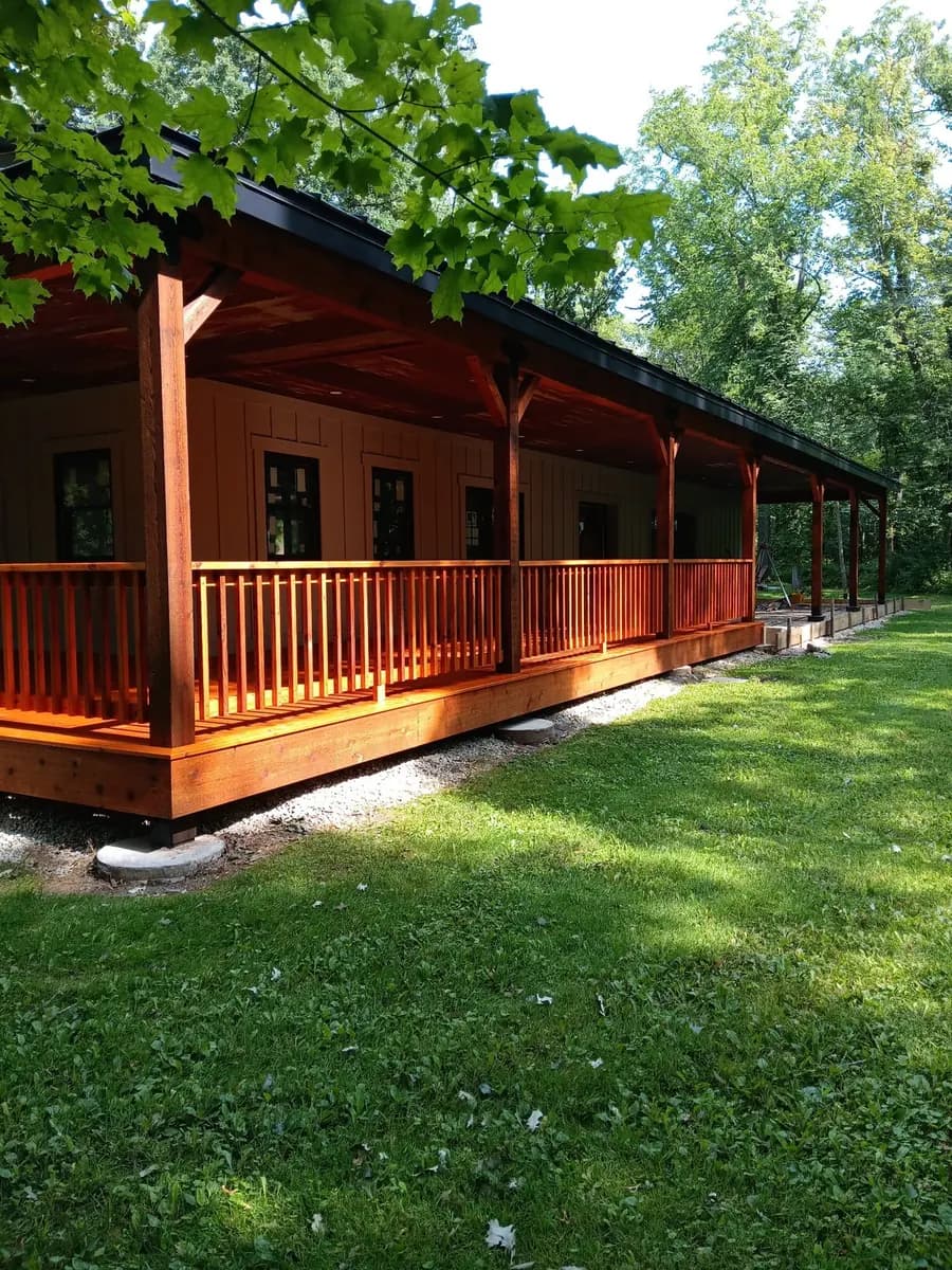 Completed covered porch with consistent cedar-toned finish.