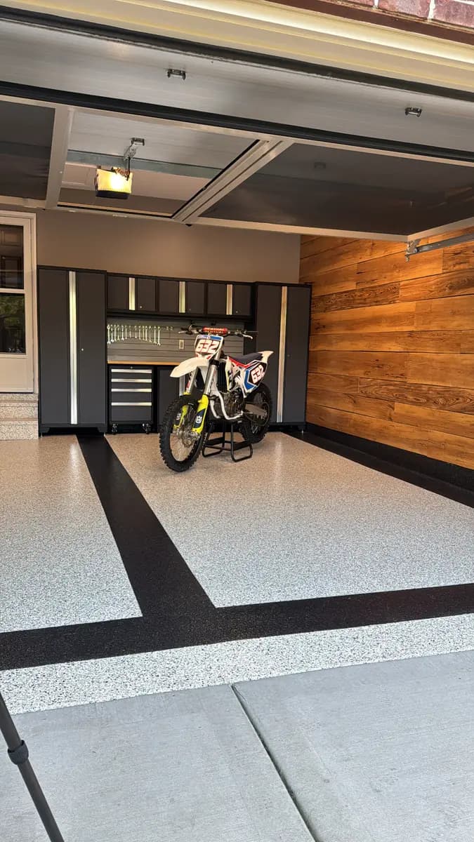 Finished garage with a custom flake epoxy floor and storage cabinetry.