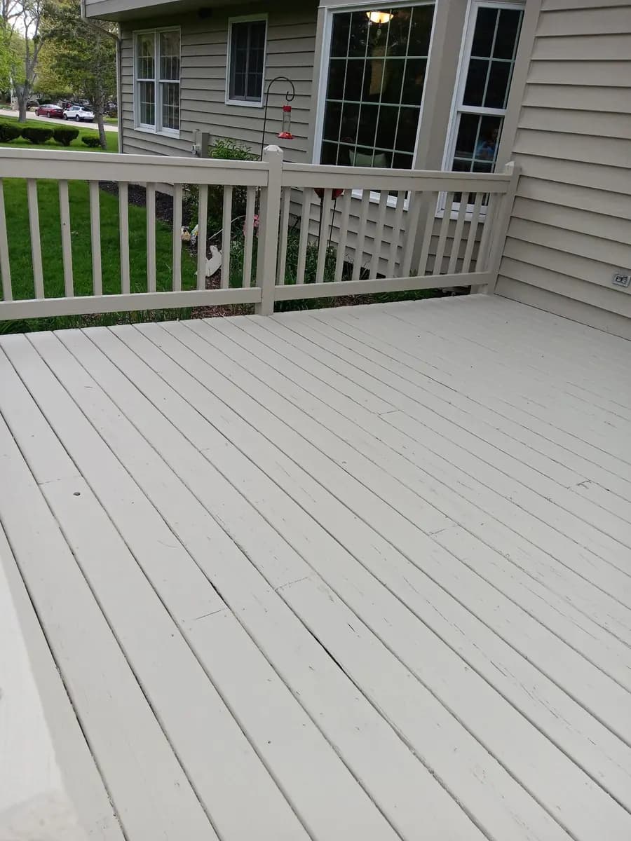 Refinished deck surface with a uniform neutral coating.