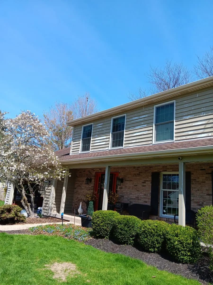 Wide front view of the two-story exterior siding project.