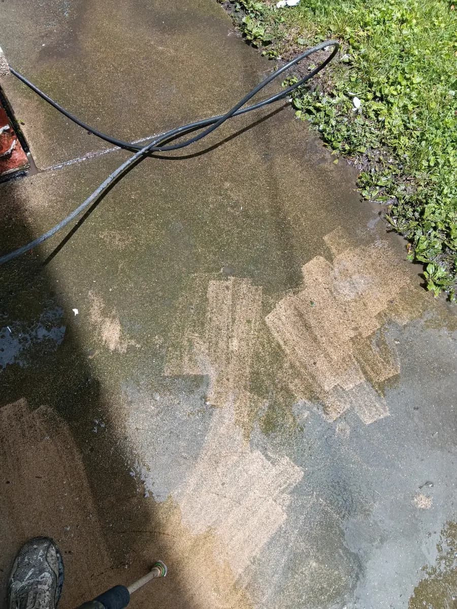 Concrete cleaning in progress near the entry steps.