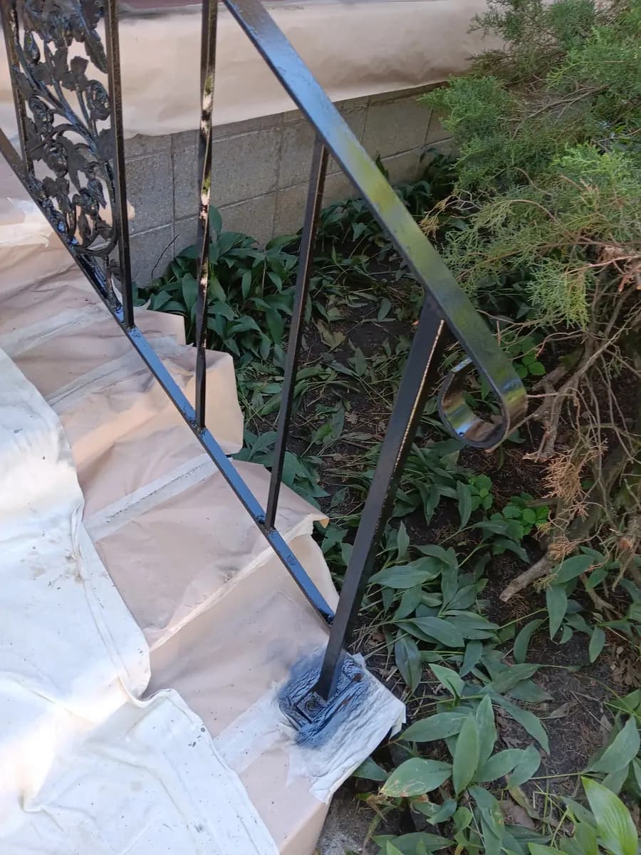 Restored iron stair railing along the side entrance.