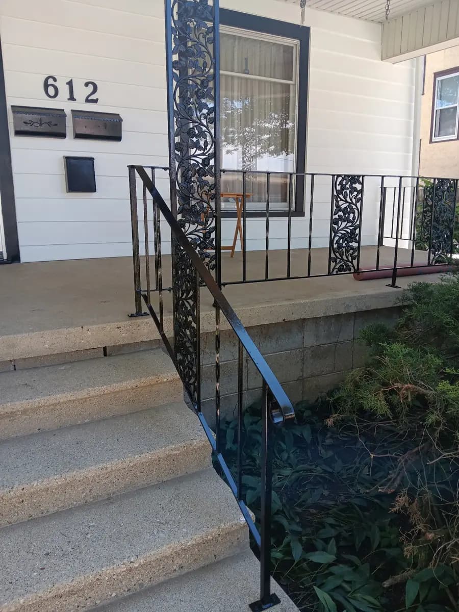 Painted entry steps leading up to the restored iron railing.