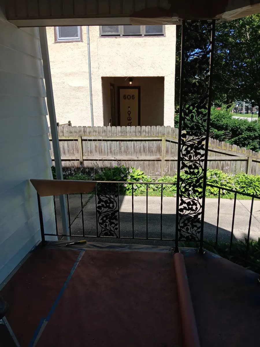 Covered entry porch after painting, viewed from the doorway.