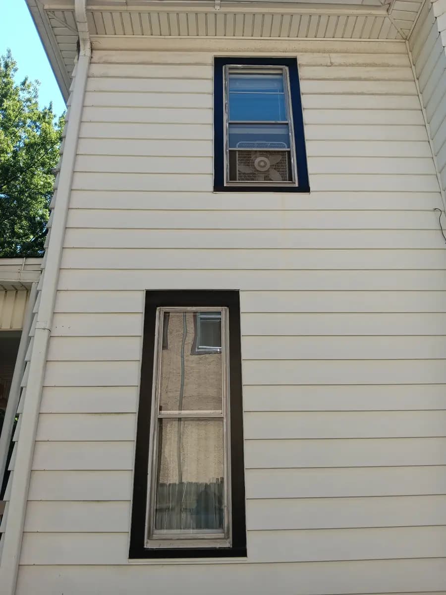 Repainted upper-story siding and window trim.